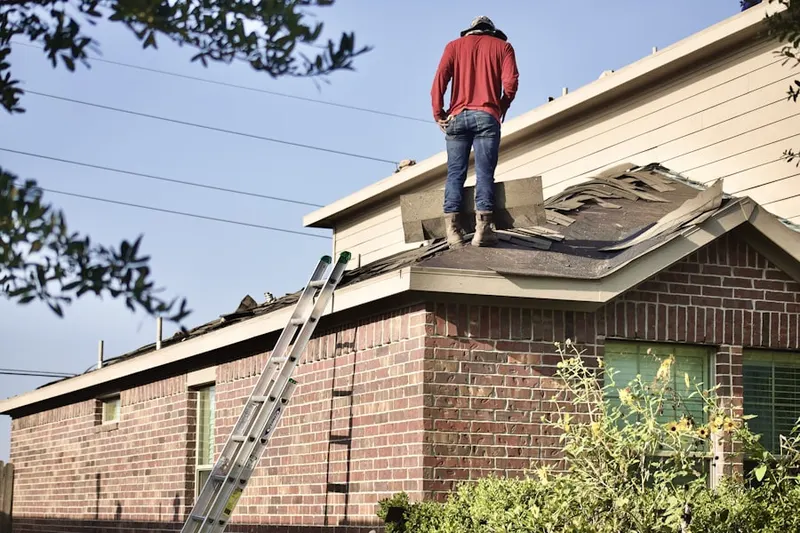 Professional roofer working on a residential roof in Northeast Aurora